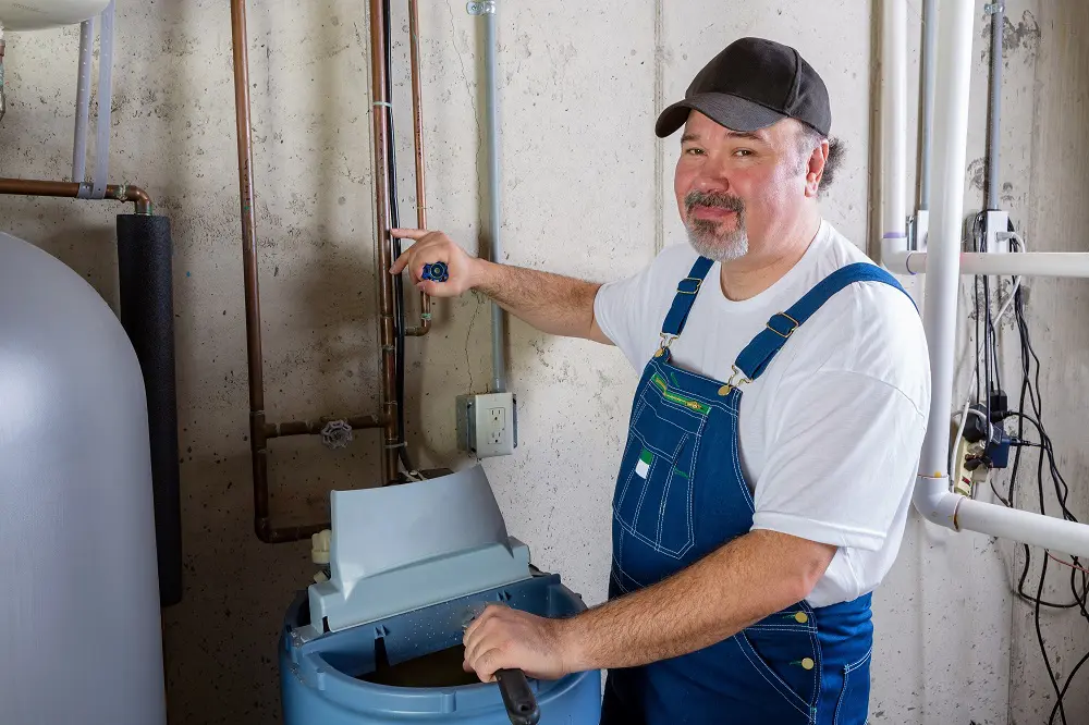 Worker installing water softener