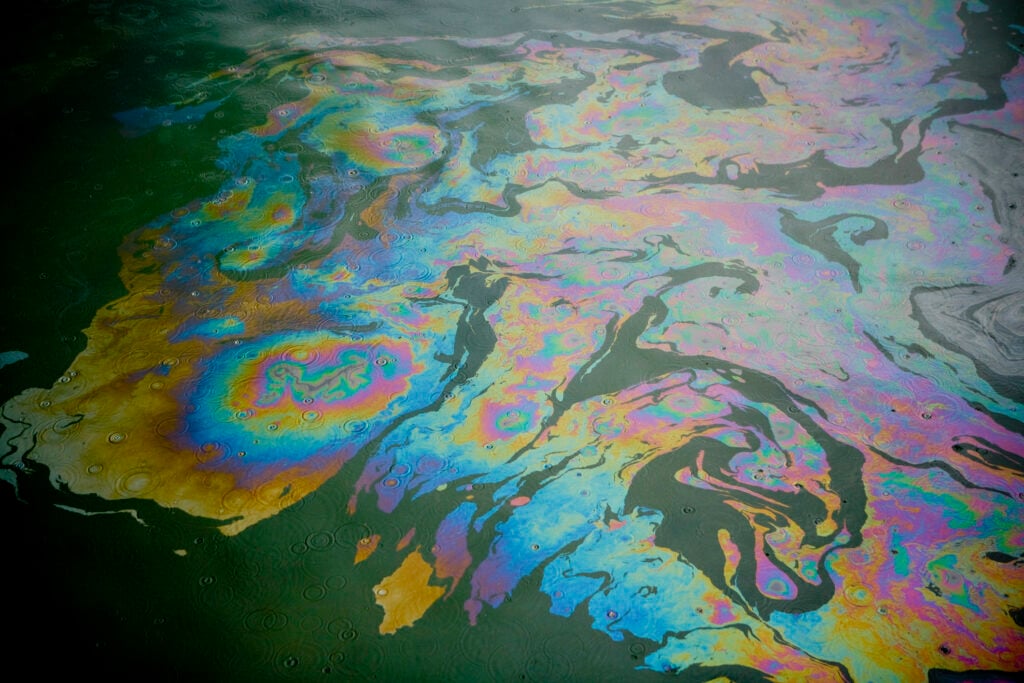 Colorful patterns of oil pollution on water.
