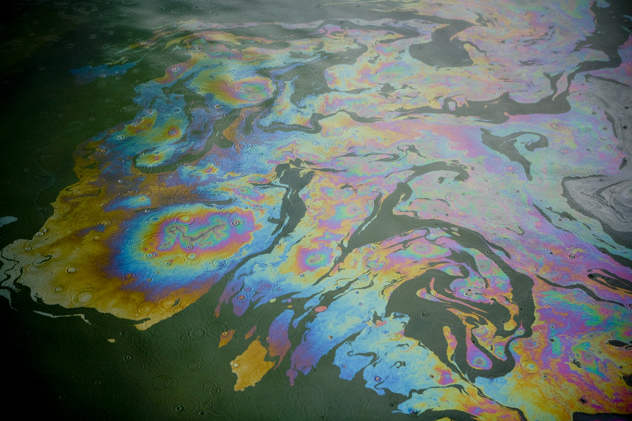 Colorful patterns of oil pollution on water.