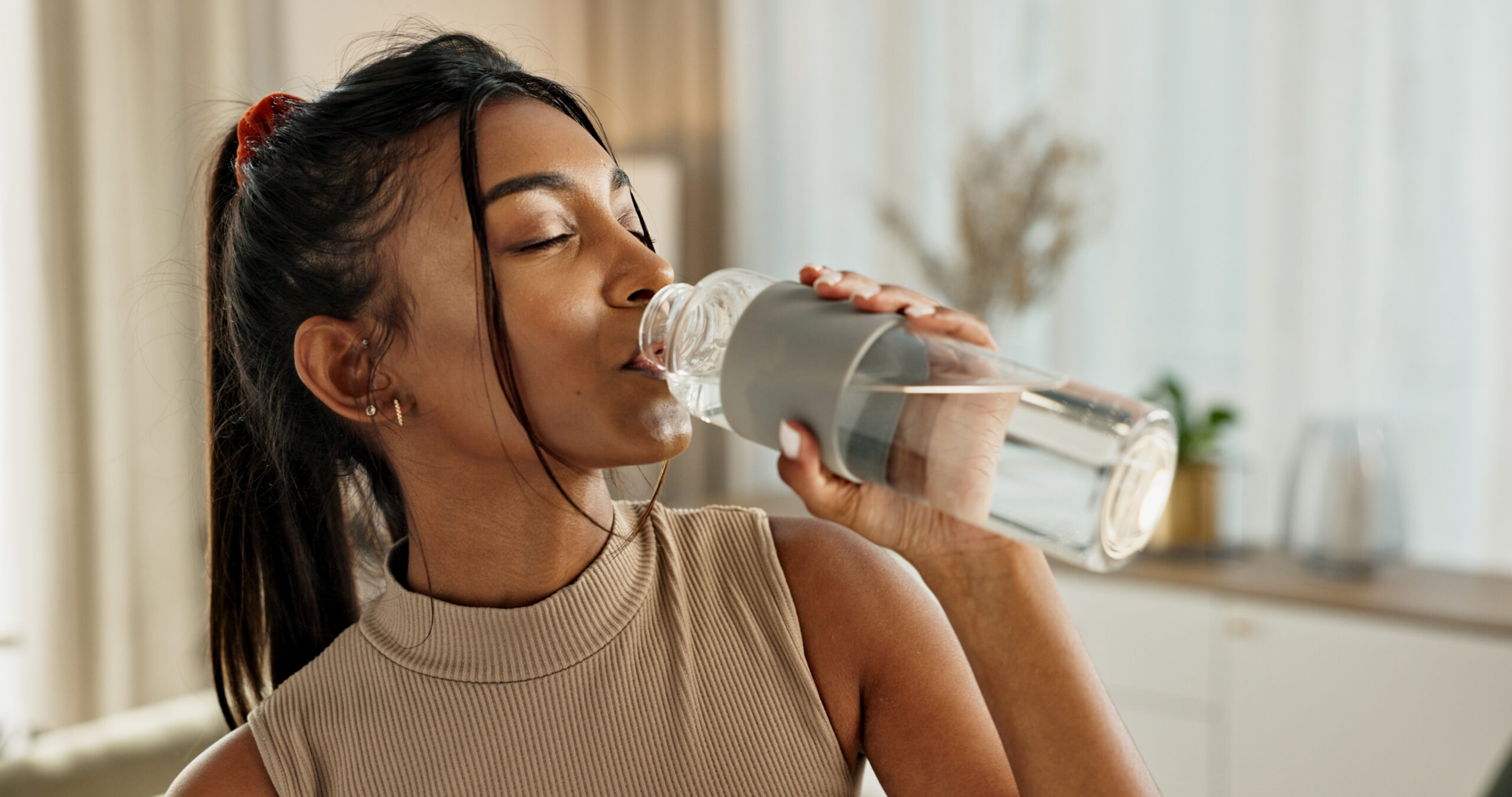 A woman drinking water.