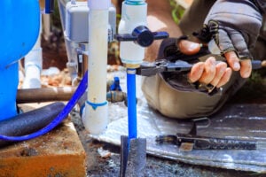 A PVC pipe being connected to a water supply system.