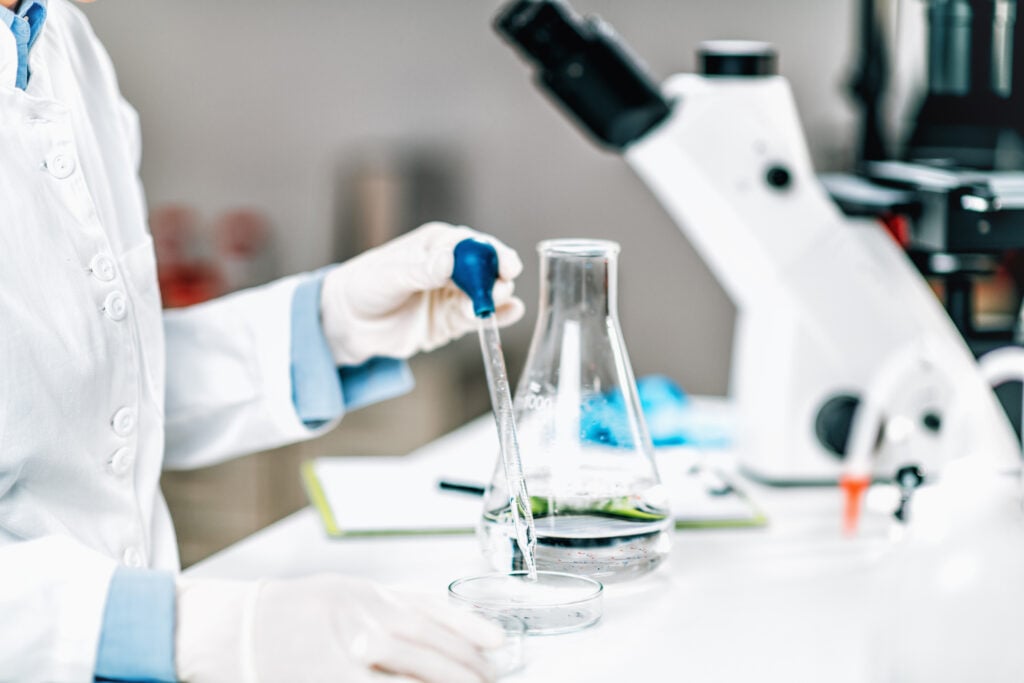 A scientist analyzing microplastic pollution in a water sample.