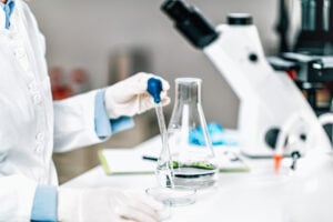 A scientist analyzing microplastic pollution in a water sample.