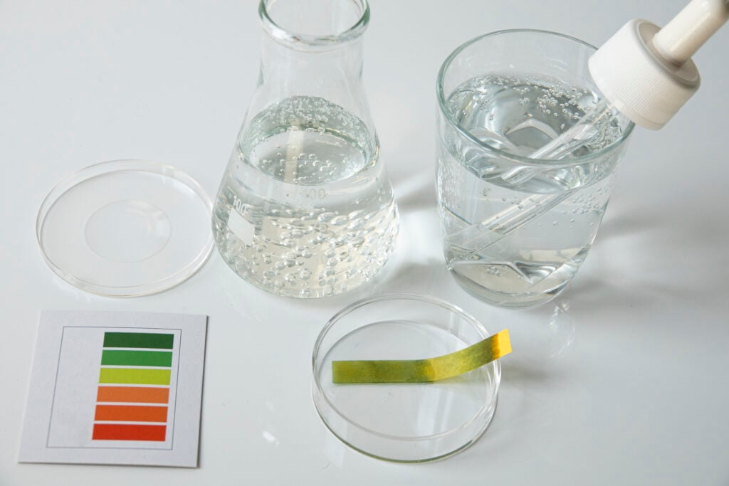 DIY water testing kit laid out on a table with sample containers and instruction sheet